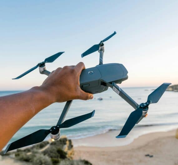 DJI drone for video in man's hand at the beach